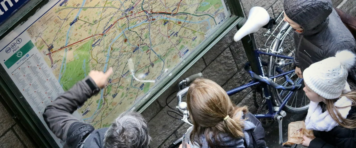 a group of people looking at a map